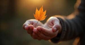 Open hand releasing a dry autumn leaf